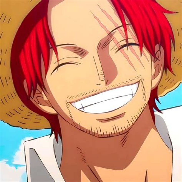 Shanks smiling while wearing the Straw Hat in One Piece